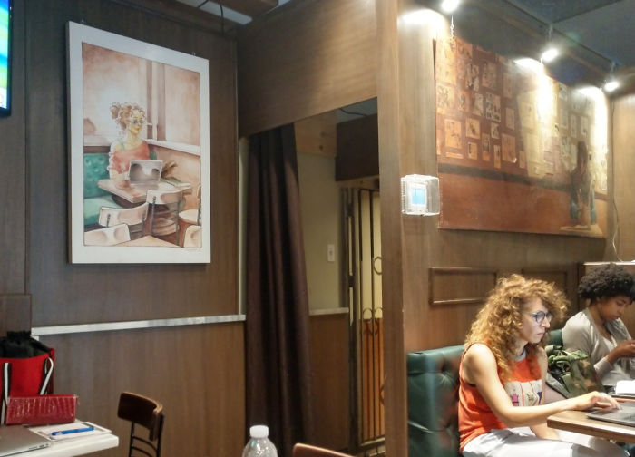 This Woman At A Cafe Really Resembles The Woman In The Painting Right Behind Her