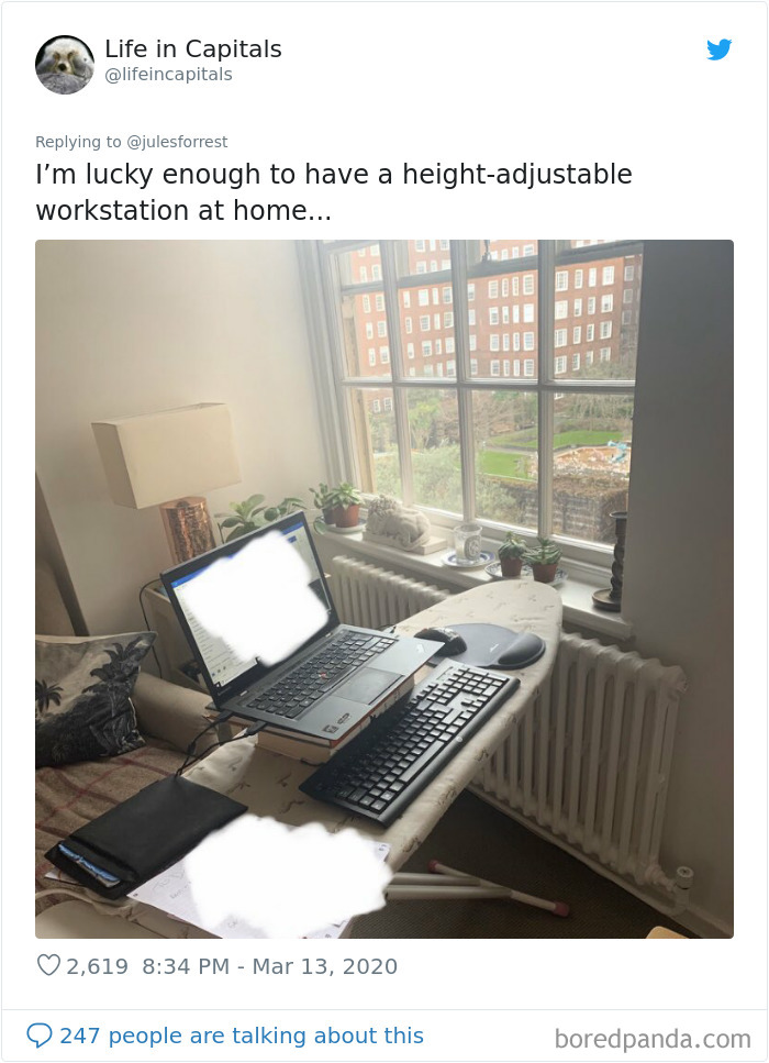 Improvised work from home setup using an ironing board as a height-adjustable workstation by someone tired of glamorous setups.