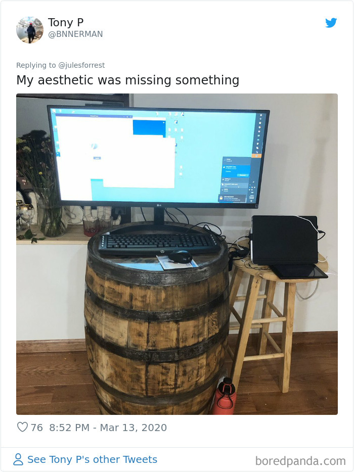 Rustic home workspace setup with a computer monitor on a wooden barrel, showing the reality of working from home.