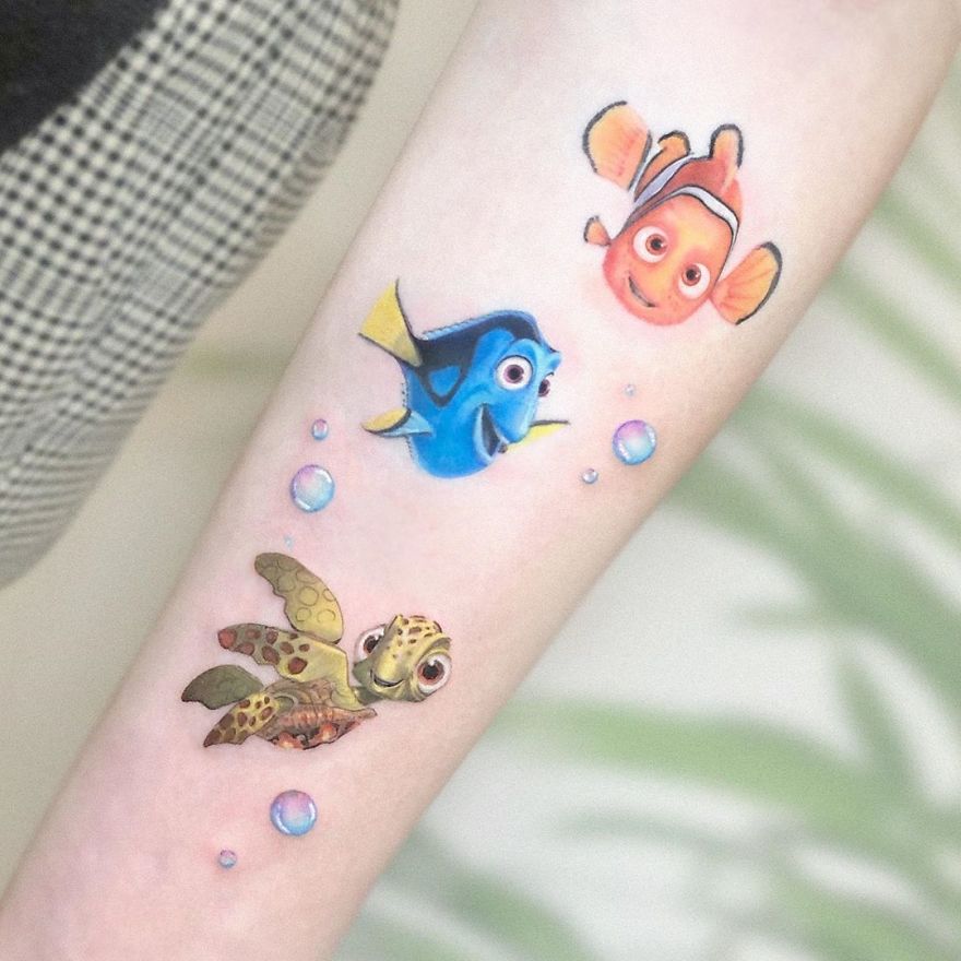 Colorful micro tattoos by Eden Kozokaro featuring vibrant fish and bubbles, resembling mini pop culture paintings.