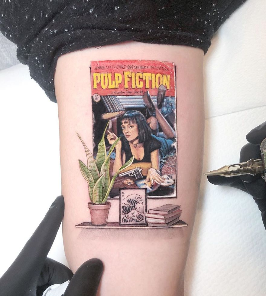 Colorful micro tattoo by Eden Kozokaro depicting a scene from pop culture, resembling a mini painting on skin.
