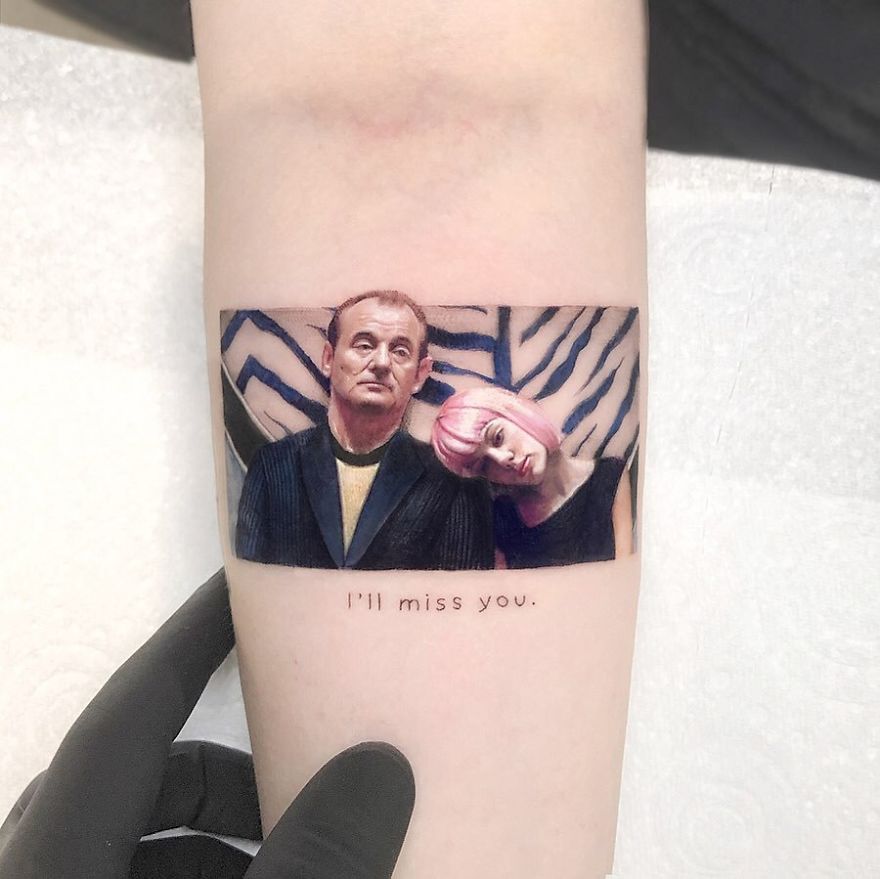 Colorful micro tattoo by Eden Kozokaro depicting pop culture scene with two figures, one resting head on the other.