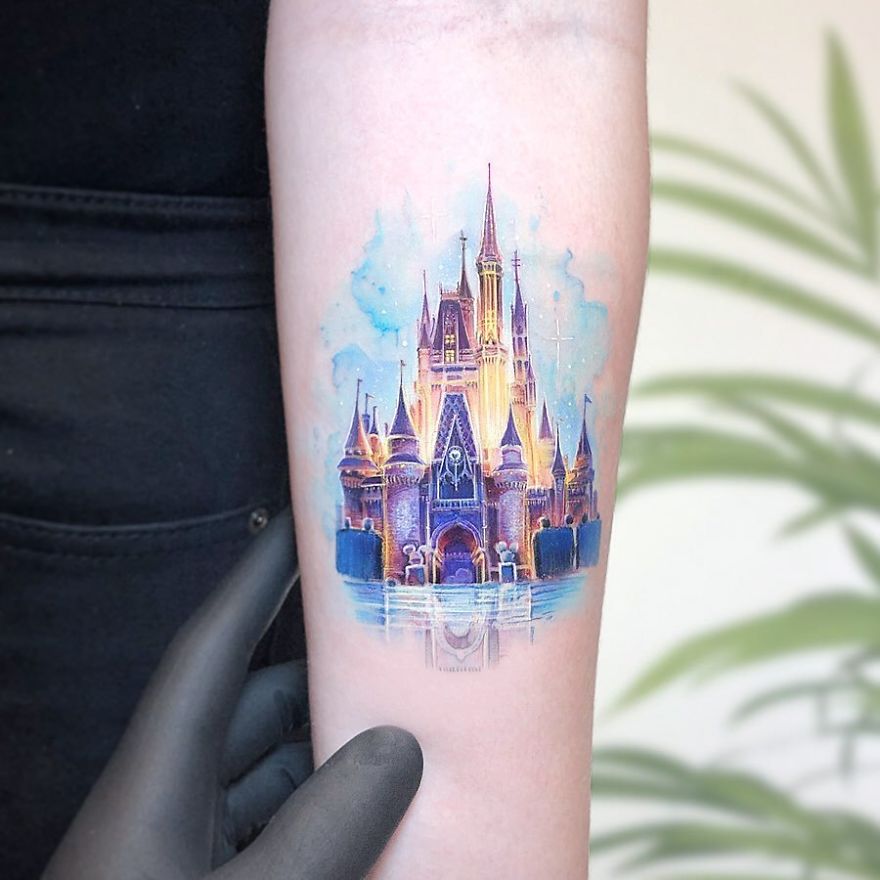 Colorful micro tattoo of a castle on forearm, resembling pop culture art by Eden Kozokaro.