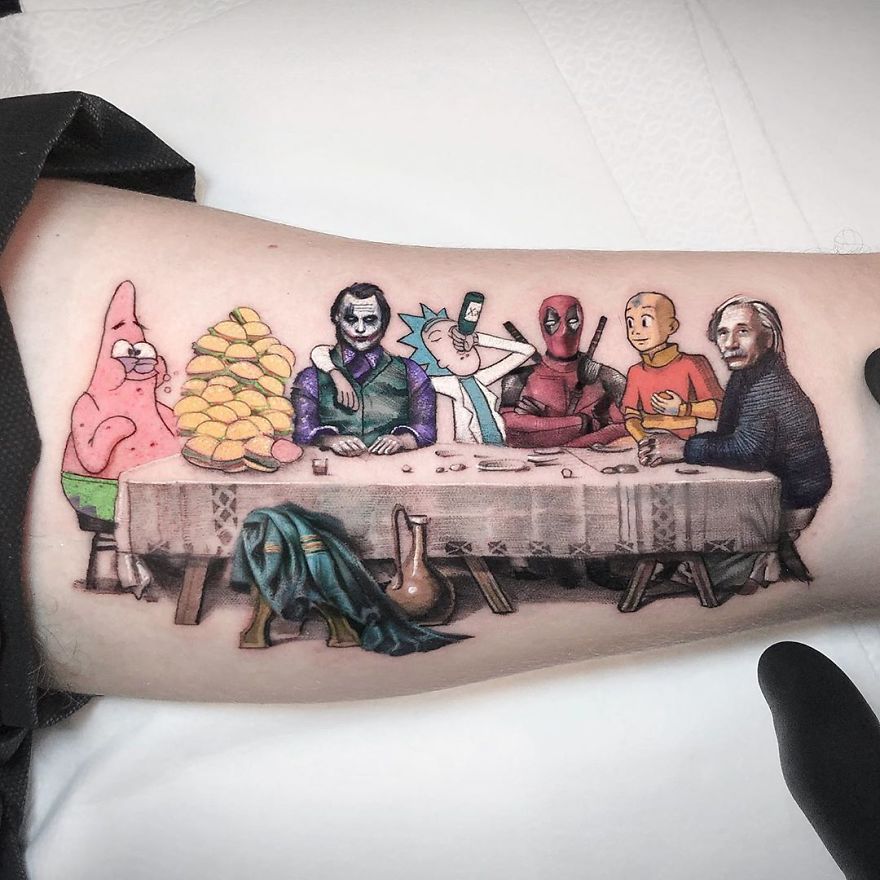 Colorful micro tattoo by Eden Kozokaro featuring pop culture characters seated at a table.