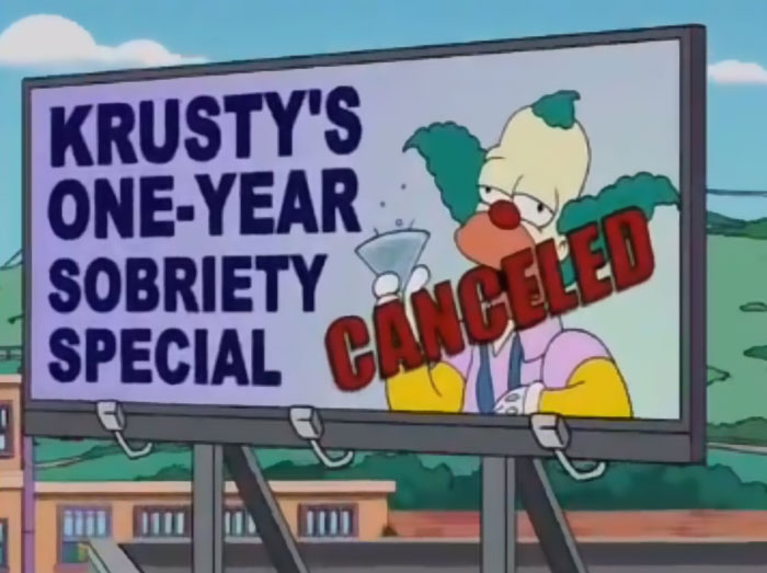 Billboard in The Simpsons showing Krusty clown with a martini glass and canceled sobriety sign joke for witty signs.