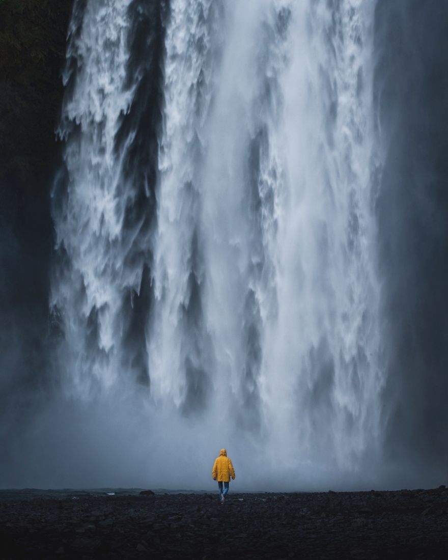 A Person In Yellow At Skogafoss