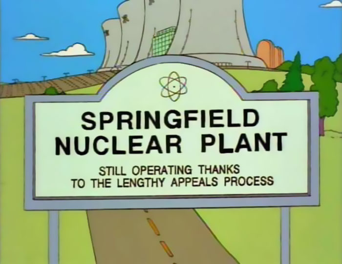 Sign at Springfield Nuclear Plant from The Simpsons humorously referencing appeals process among witty signs found in the series.