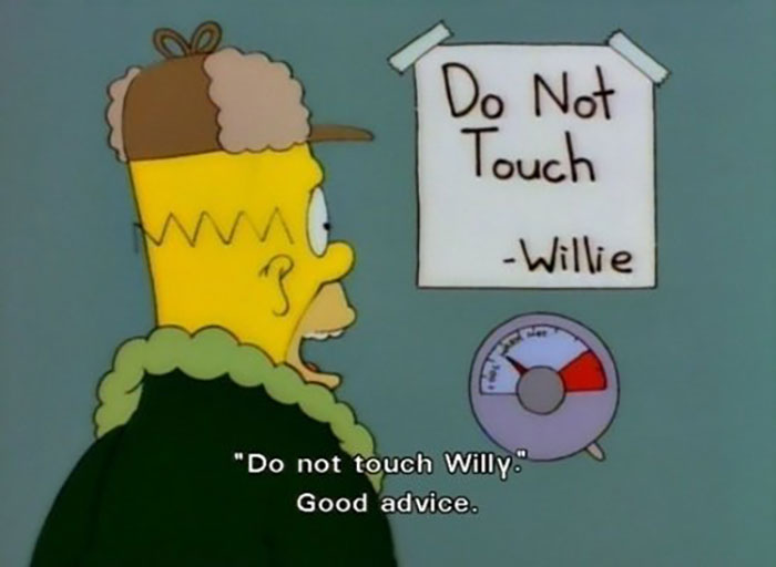 Homer Simpson reading a witty sign saying Do Not Touch Willie, illustrating humor from signs found in The Simpsons.