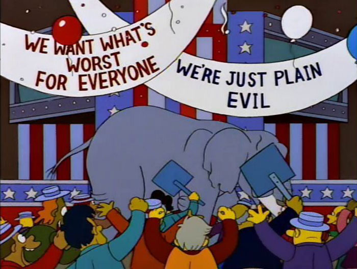 Crowd of animated characters holding signs with witty messages at a political event in The Simpsons.