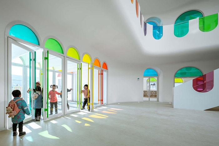 483 Rainbow-Colored Glass Panels Emit A Rotating Kaleidoscope In This Playful Kindergarten