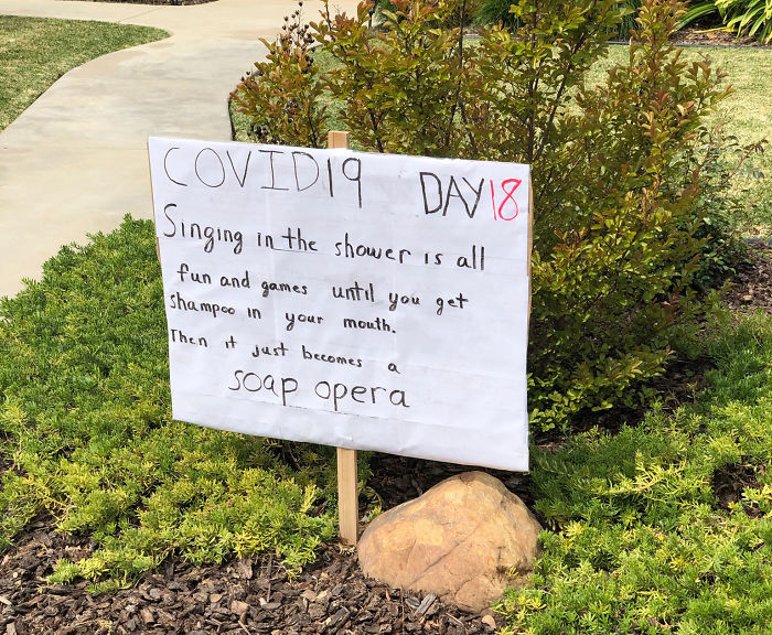 Neighborhood laughter with daily dad joke sign during quarantine: "Singing in the shower... soap opera.