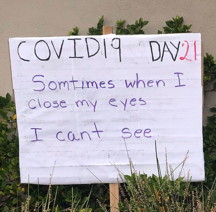 Dad joke sign from quarantine day 21: "Sometimes when I close my eyes I can't see," in front of a garden.
