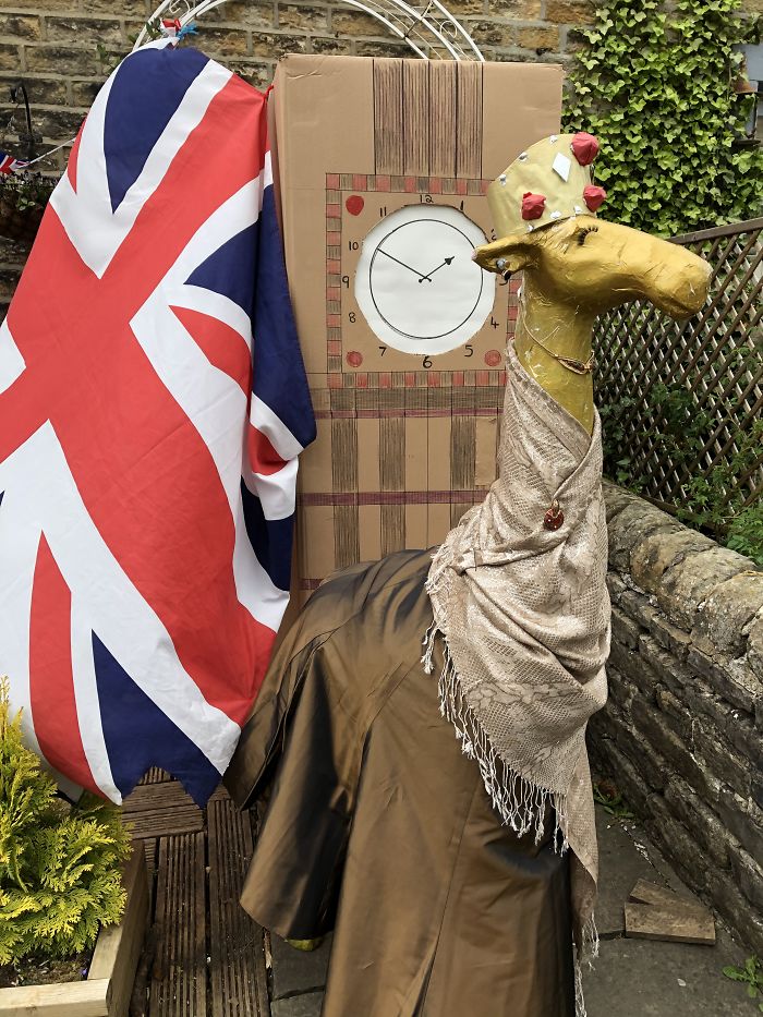 Gloria The Giraffe As Her Majesty The Queen Standing In Front Of Big Ben