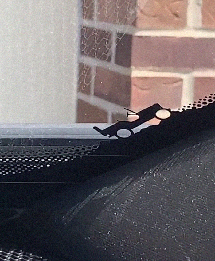 Black small car on the car window Black small car on the car window