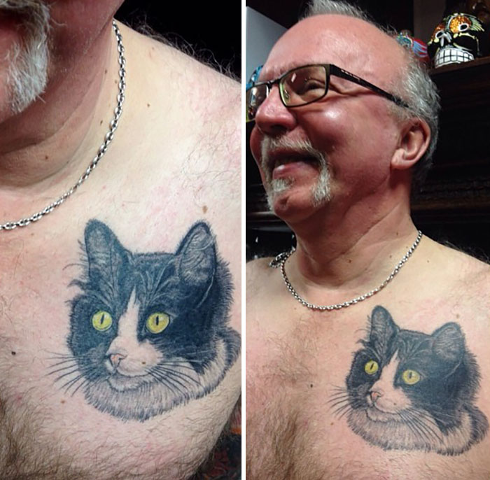 Senior man with a cat tattoo on his chest, smiling while wearing glasses.
