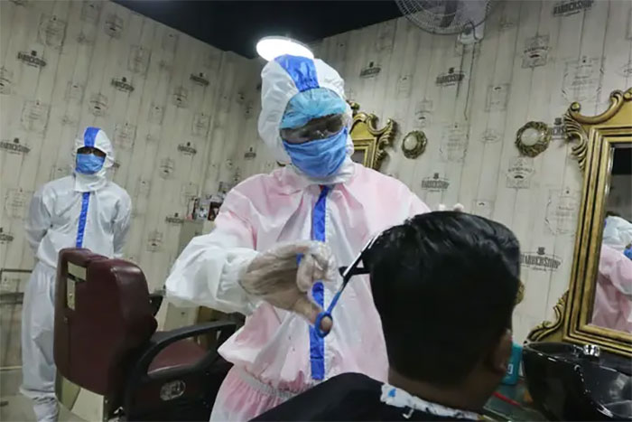Barbers Wear Full-Body Protective Suits While Cutting People's Hair In Bangladesh