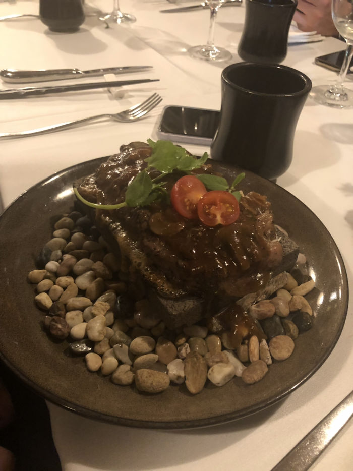 Steak On A Rock With Pebbles Underneath