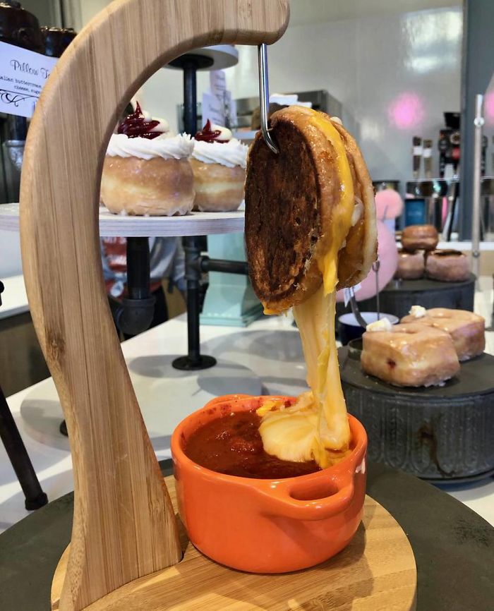 Grilled Cheese Served On A Hook, Dripping Into The Soup Below
