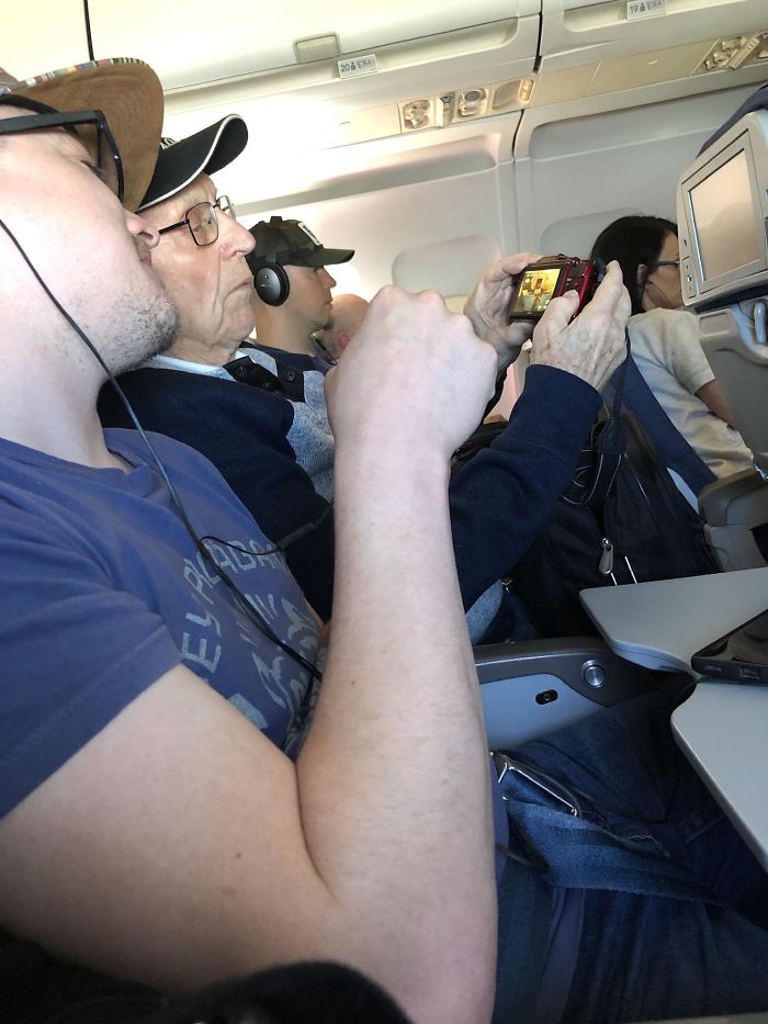 This 95-Year-Old Man Sharing His Holiday Photos With A Stranger During Their Flight