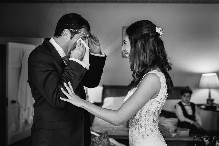 Emotional unstaged father-daughter moments at weddings captured with black and white photography showing genuine connection.