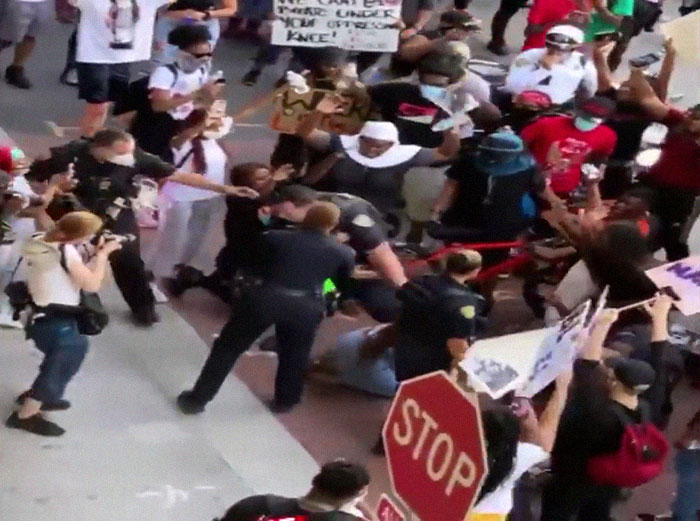 After A Cop Pushed A Kneeling Woman, Black Female Police Officer Stands Up For Her After A Cop Pushed A Kneeling Woman, Black Female Police Officer Stands Up For Her