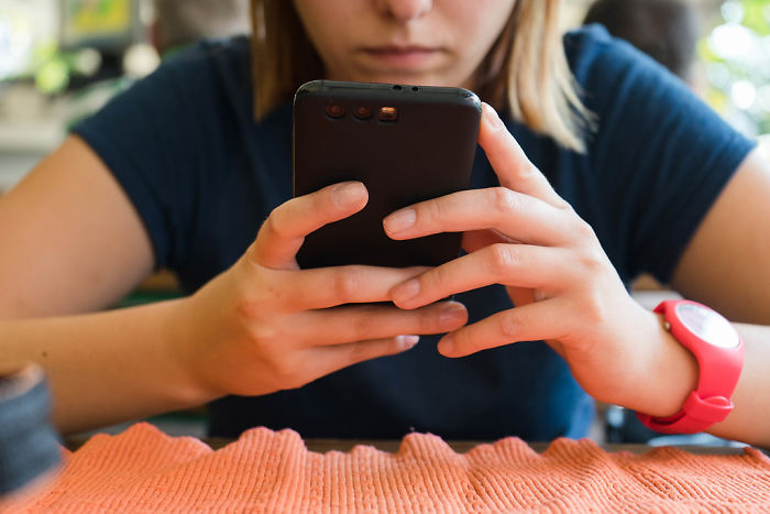 Person using a smartphone, illustrating concerns about TikTok's privacy issues revealed by reverse-engineering expert.