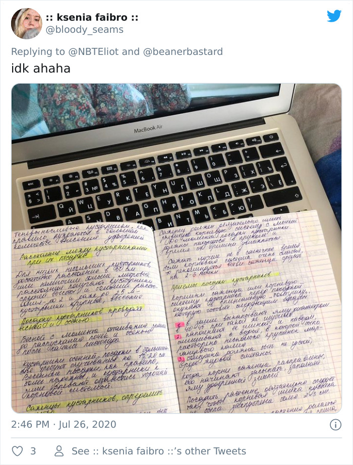 Handwritten Russian cursive notes with highlighted text placed on a MacBook Air keyboard, illustrating Russian cursive.