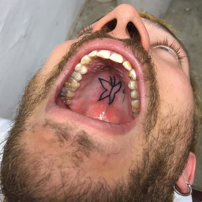 Tattoo inside a mouth, showcasing unconventional canvas for body art by a creative tattoo artist.