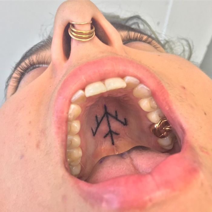 Tattoo on the roof of the mouth, showcasing unconventional body art by a tattoo artist.