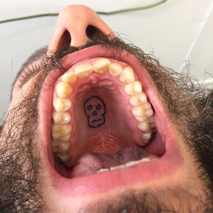 Tattoo artist's unconventional tattoo of a skull on the roof of the mouth.