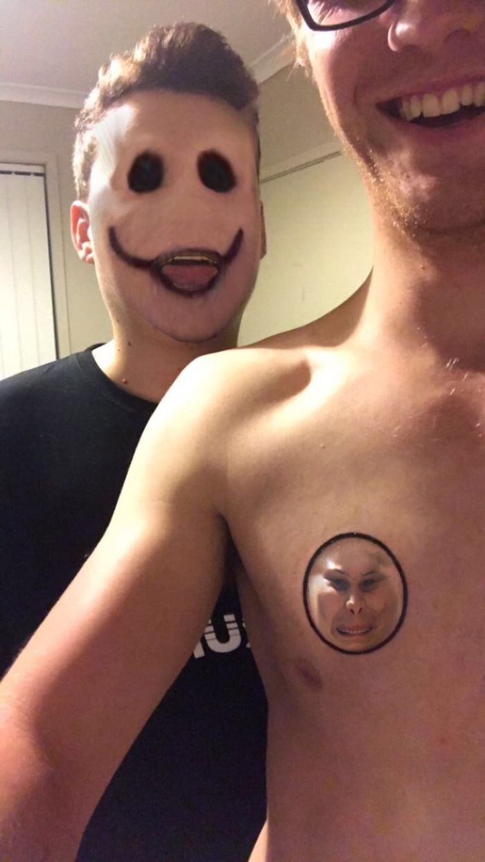 Face swapping tattoos on a man's chest with unsettling expressions and altered faces in a selfie.