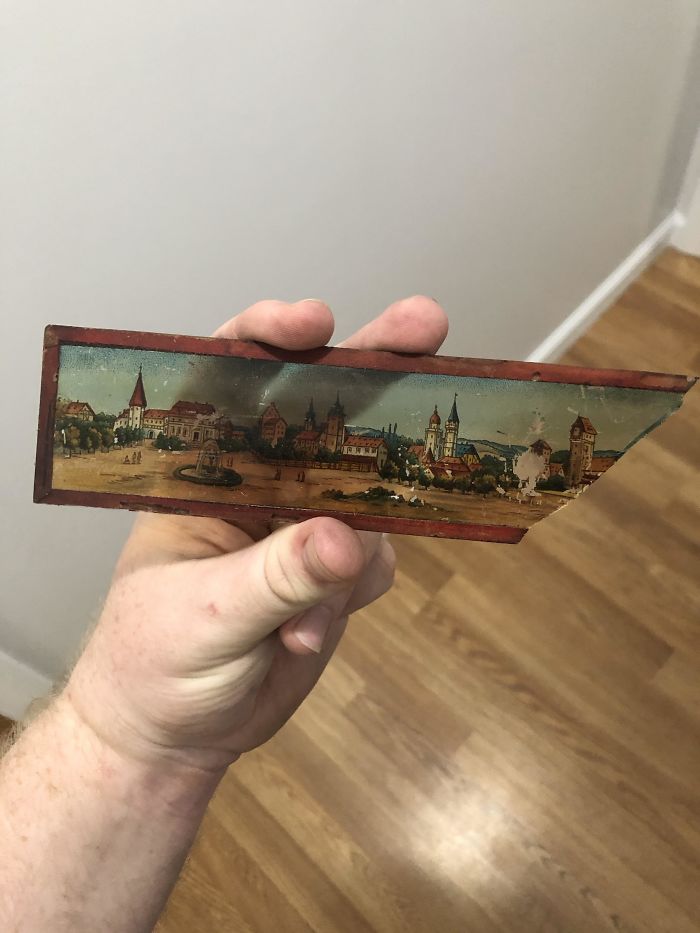 Found This Hidden In The Ceiling Of My Basement With A Bunch Of Others. Made Out Of Glass, Appears To Have Some Sort Of Tape Or Paper Border Around It. Hining A Light Through It Doesn’t Project A Clean Image. What Is This Thing?