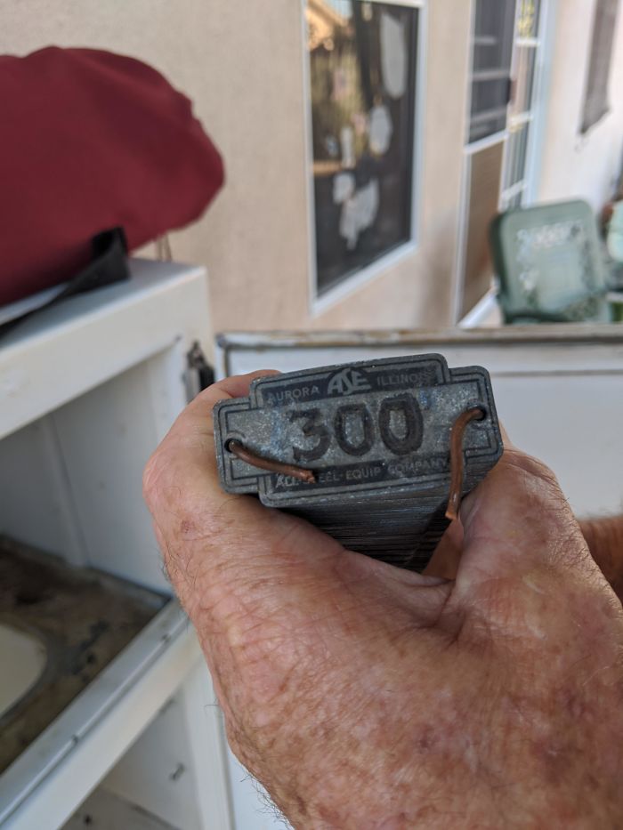 1 Through 300 Metal Tags Found In An Old (1920s)ice Box. The Copper Wires Are There Just To Hold The Whole Stack Together