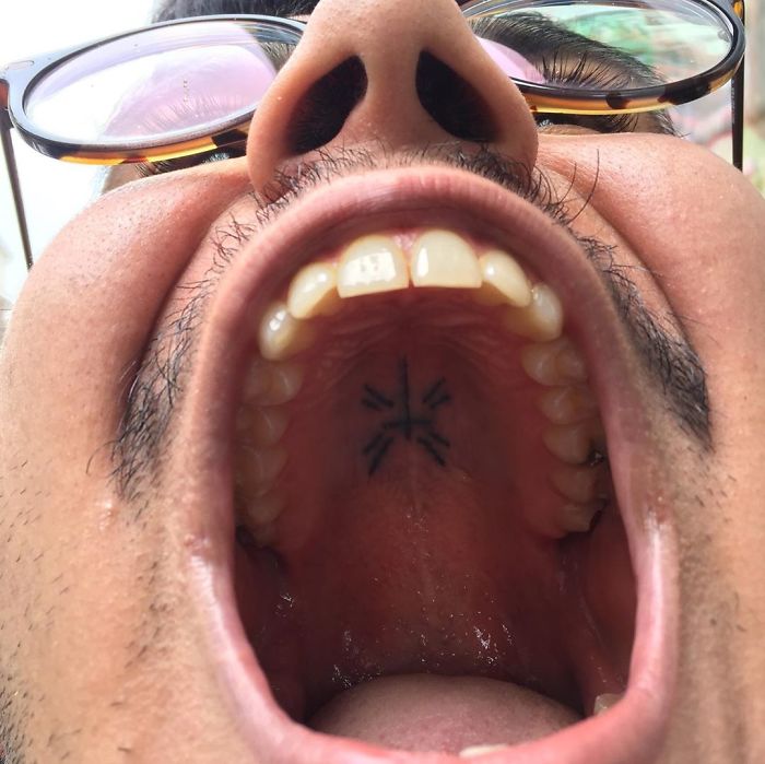 Tattoo on the roof of the mouth, showcasing unconventional body art by a creative tattoo artist.