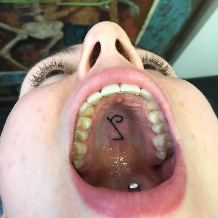 Tattoo on the roof of a mouth, showcasing unconventional body art by an innovative tattoo artist.