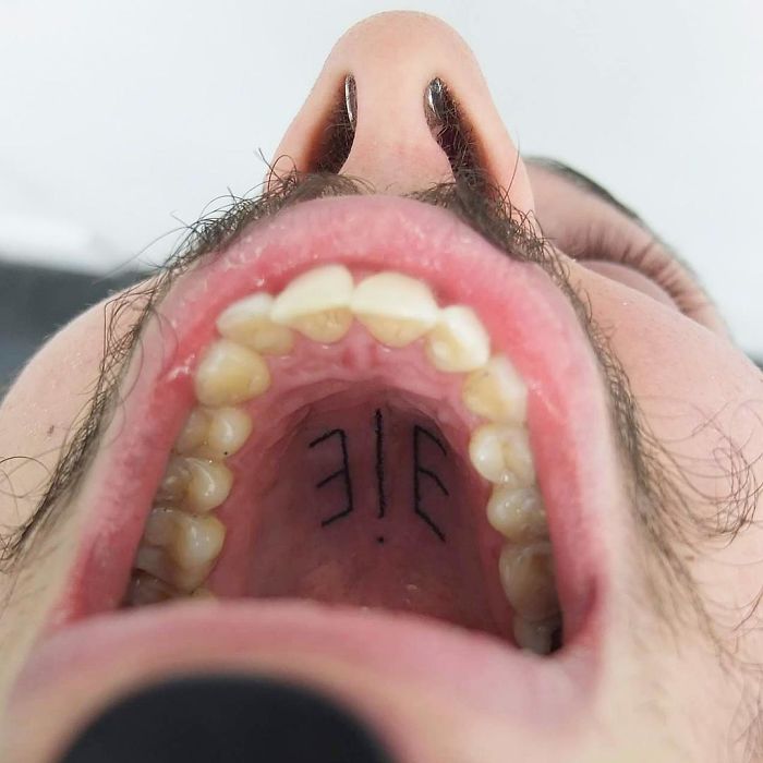 Tattoo on the roof of the mouth, showing creative use of unconventional body part as canvas.