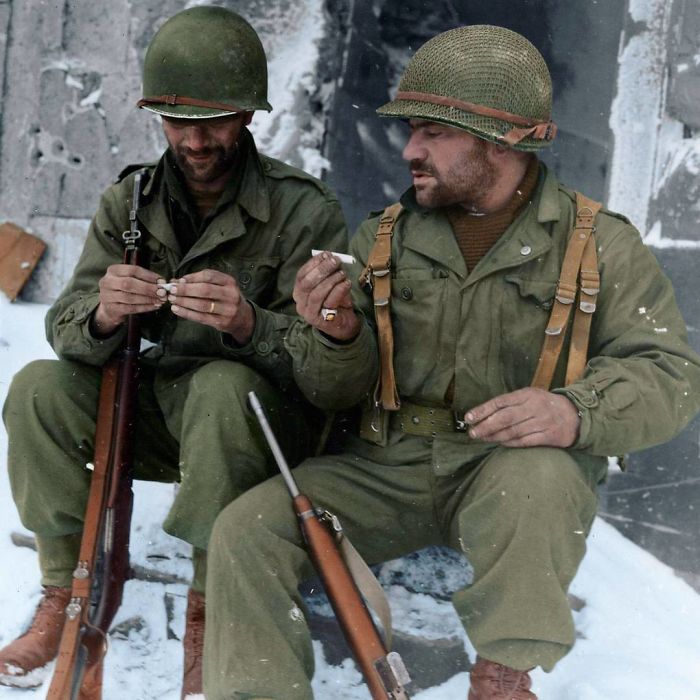 Two Riflemen From The 317th Infantry Regiment, 80th Infantry Division, Take A Moment To Roll Their Own Cigarettes In Goesdorf (Luxembourg), January 10, 1945