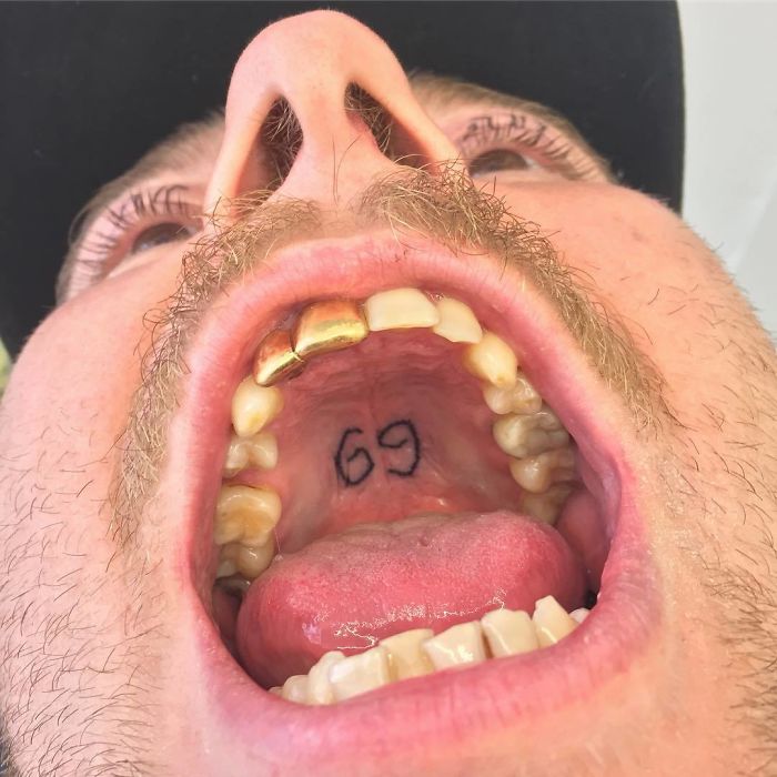 Tattoo artist's unconventional tattoo of number 69 on the roof of the mouth.