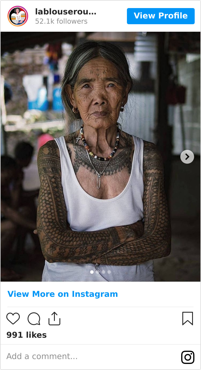 Elderly woman with traditional tattoos, preserving ancient Filipino tattoo tradition, standing with arms folded. Elderly woman with traditional tattoos, preserving ancient Filipino tattoo tradition, standing with arms folded.