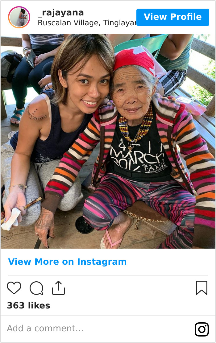 Elderly Filipino woman with traditional tattoos sitting beside a younger woman, showcasing ancient tattoo tradition. Elderly Filipino woman with traditional tattoos sitting beside a younger woman, showcasing ancient tattoo tradition.