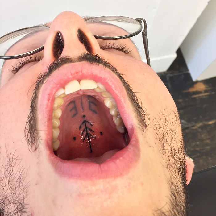 Tattoo on the roof of the mouth, showcasing unconventional body art by a tattoo artist.