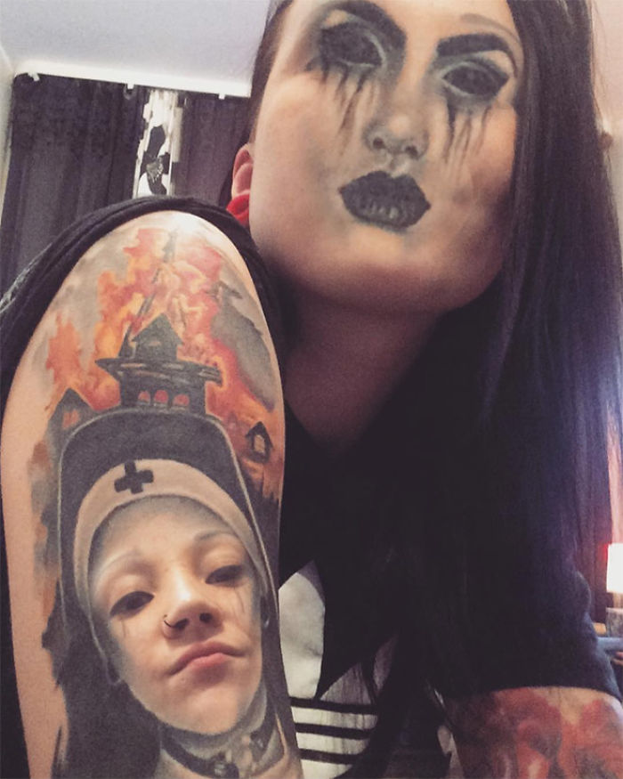Person with face-swapped tattoo on their arm, featuring a dark, dramatic face on their own head.
