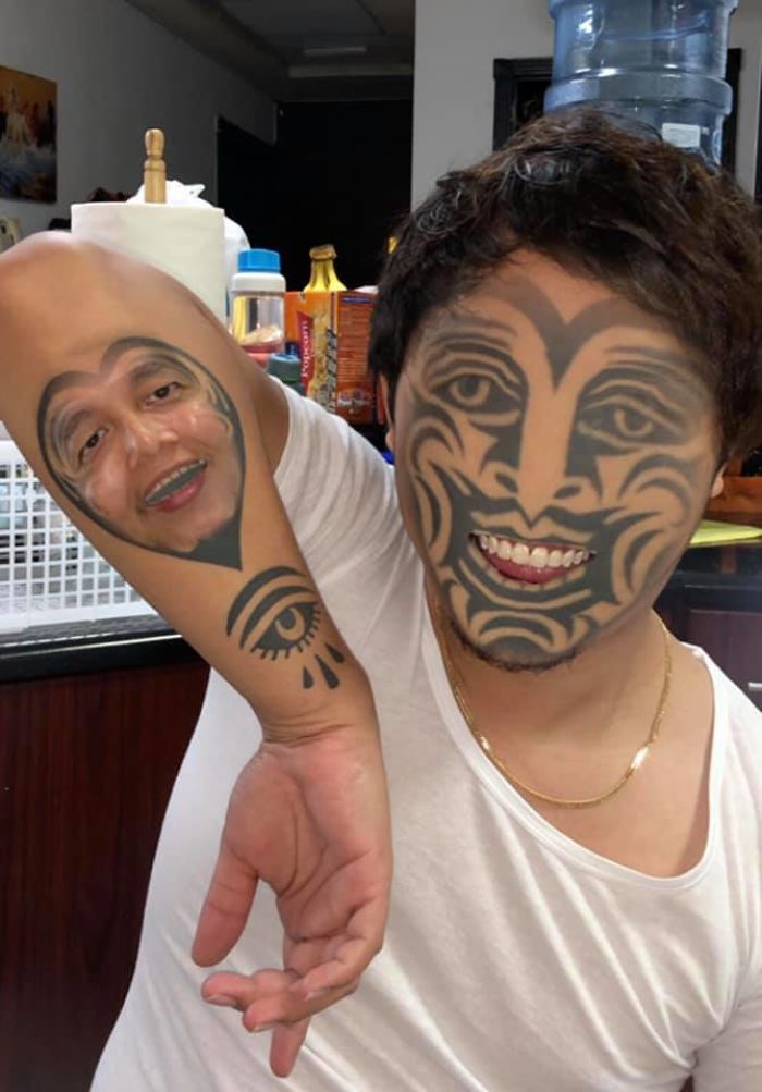 Person with tattoos of a face on their body, featuring a playful face swap effect.