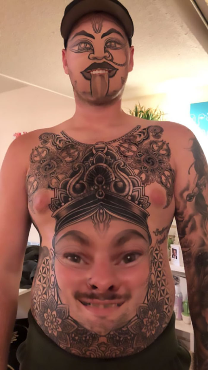 Man with face-swapped tattoos on chest and face, featuring intricate designs and a comical expression.
