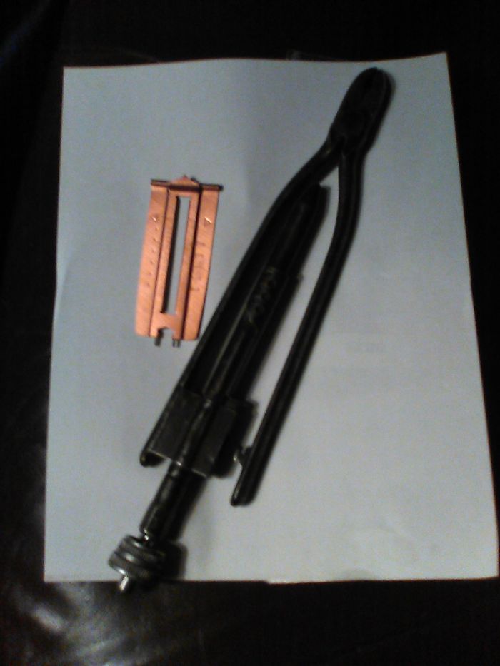 My Aircraft Safety Twist Pliers, And A Fabric-Bound Buttonhole Maker. (Honestly, I Have Much More Weird Things, But It's After Midnight And That's What I Had Closest To Me. Something I Just Thought Of: Steampunk Goggles Made From Babyfood Jar Lids And Camera Lense Parts (Includes Working Lense Shutter.)