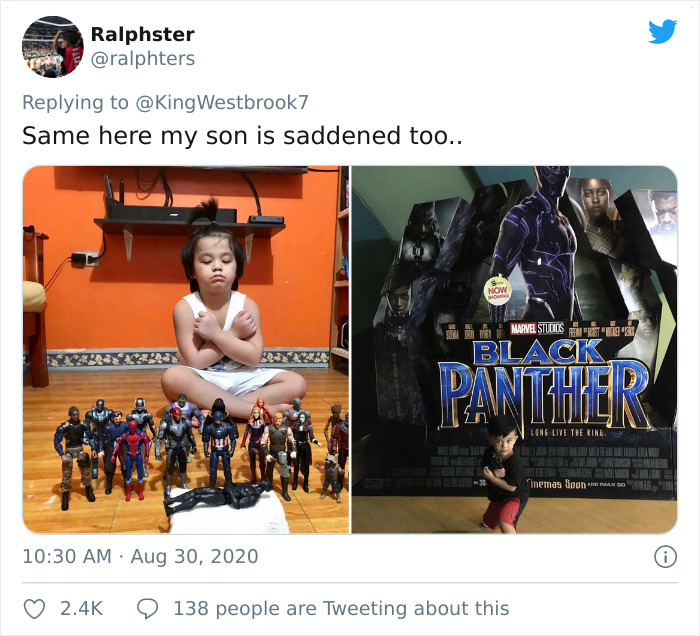 Child with Black Panther action figures and a large Black Panther movie poster as a memorial honoring the late superhero.