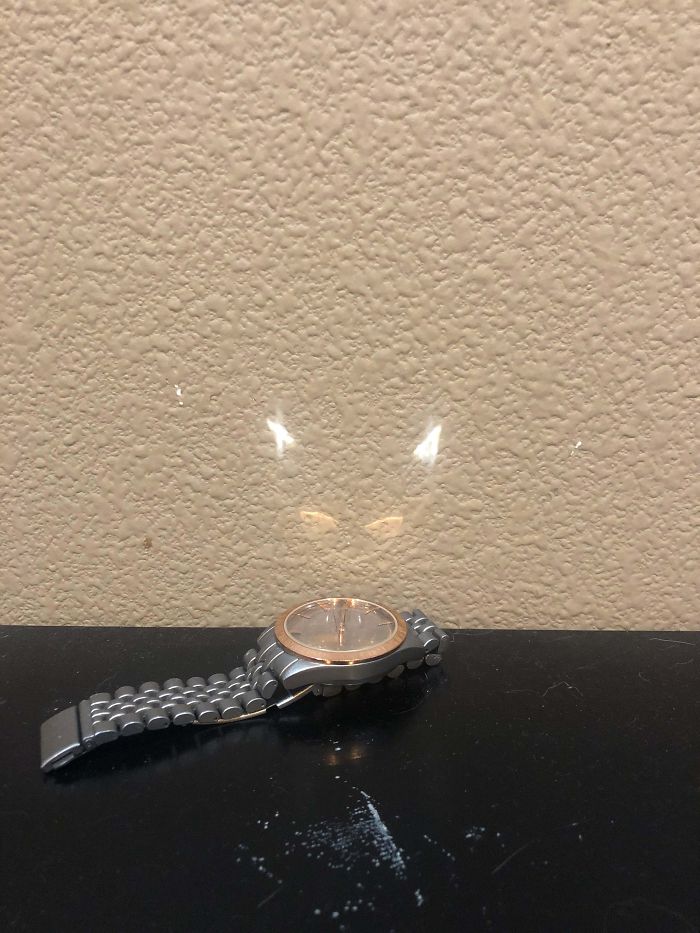 The Reflection Of This Watch Looks Like A Logo For Some Cat Super Hero.