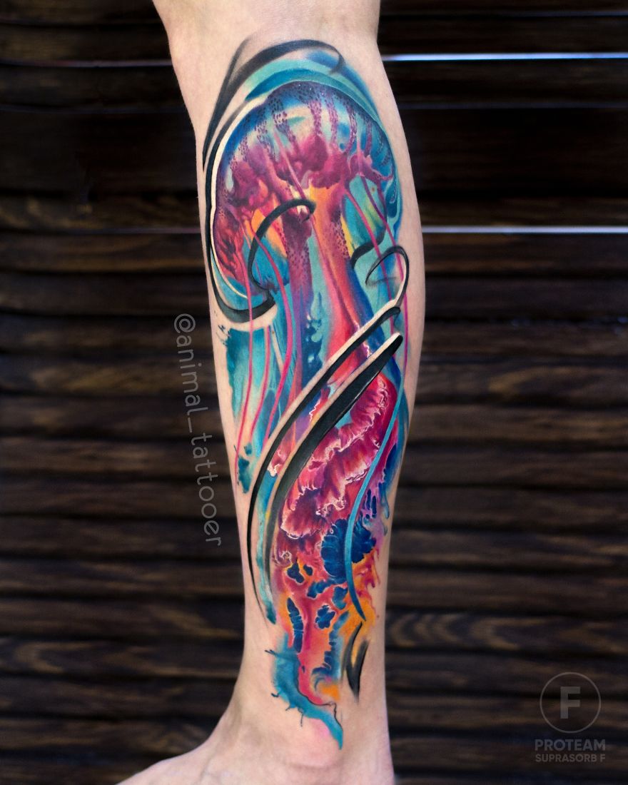 Colorful and bright jellyfish tattoo on a person's leg, showcasing animal tattoo artistry.