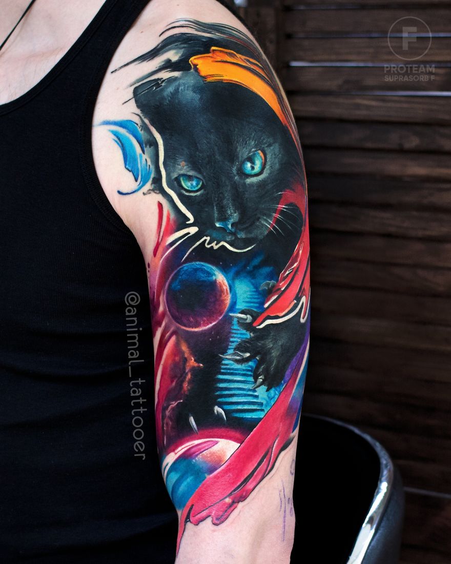Colorful and bright animal tattoo featuring a cosmic black cat on a person's arm.