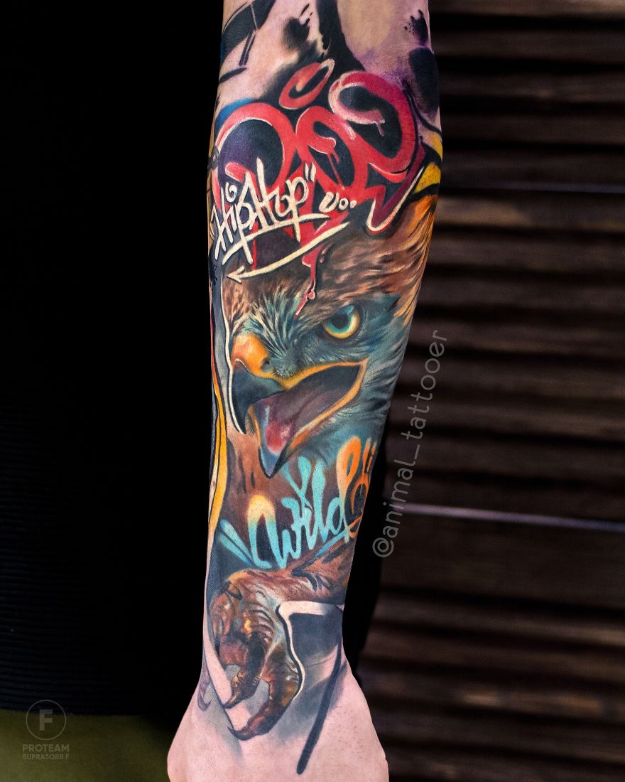 Colorful and bright animal tattoo featuring an eagle design on a person's forearm.